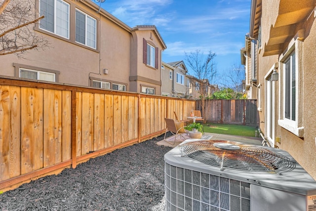 view of yard with central AC and a fenced backyard