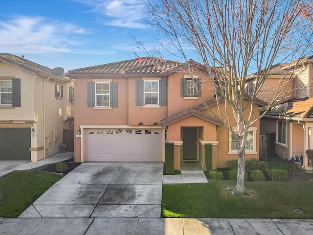 view of front of house with a tiled roof, stucco siding, an attached garage, and driveway