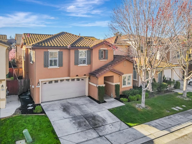 mediterranean / spanish home with a front yard, an attached garage, stucco siding, concrete driveway, and a tiled roof