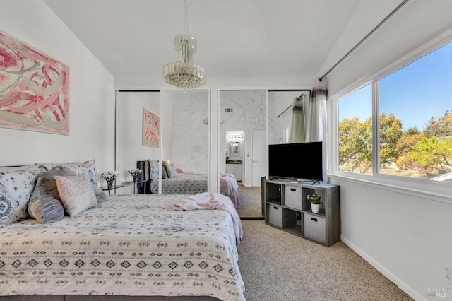 bedroom with two closets, baseboards, carpet, and lofted ceiling