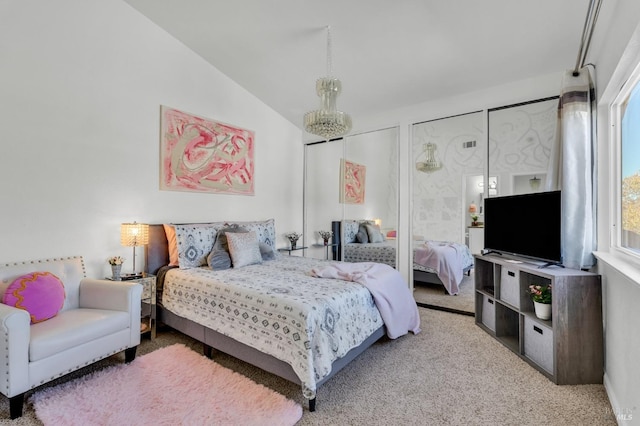 bedroom featuring lofted ceiling, carpet floors, and multiple closets