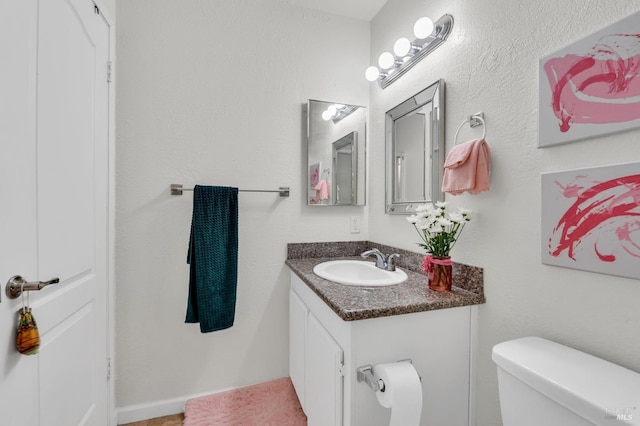 bathroom with toilet and vanity