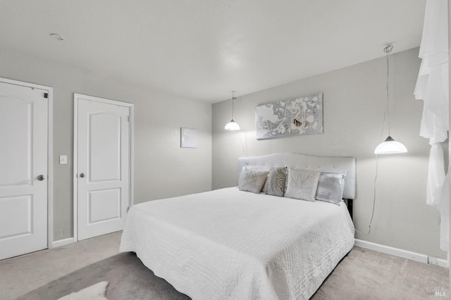 bedroom featuring carpet and baseboards