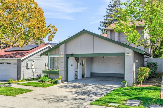 view of front of house featuring solar panels, concrete driveway, fence, and a garage