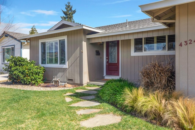 view of front of property with crawl space, roof with shingles, and a front yard