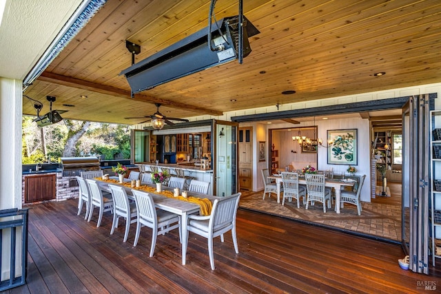 wooden terrace with ceiling fan, a grill, outdoor dining area, and a sink