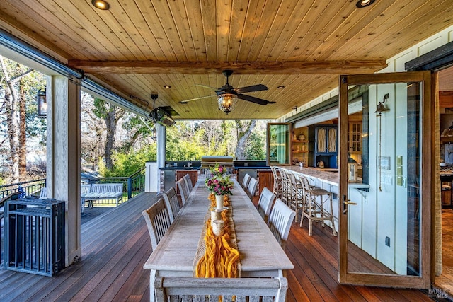 wooden terrace with a grill and ceiling fan