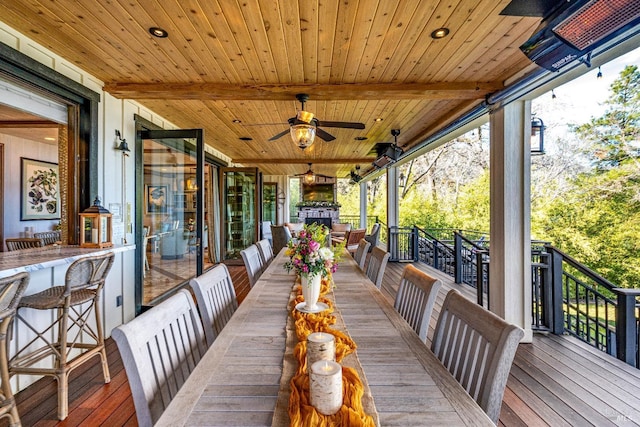 wooden deck with a ceiling fan