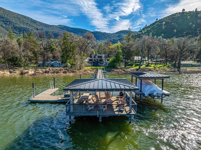 view of dock with a water and mountain view