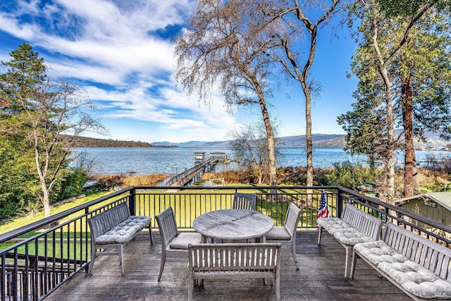 wooden deck featuring an outdoor living space and a water and mountain view