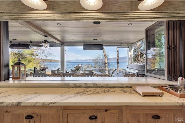 interior space featuring a water view and a grill