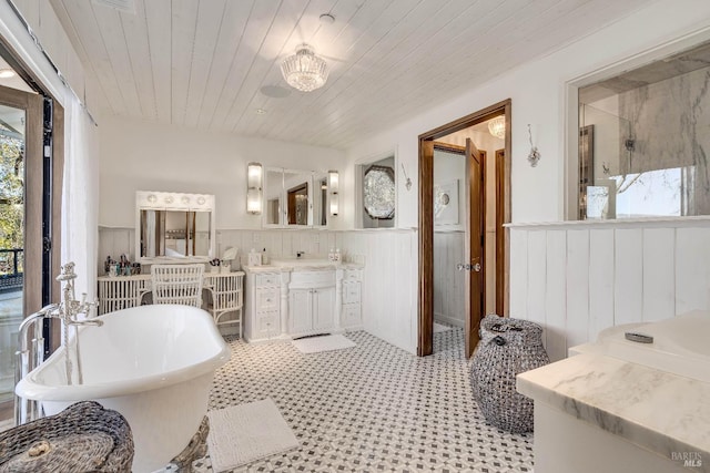 full bathroom with wooden ceiling, a wainscoted wall, a freestanding bath, vanity, and a shower stall