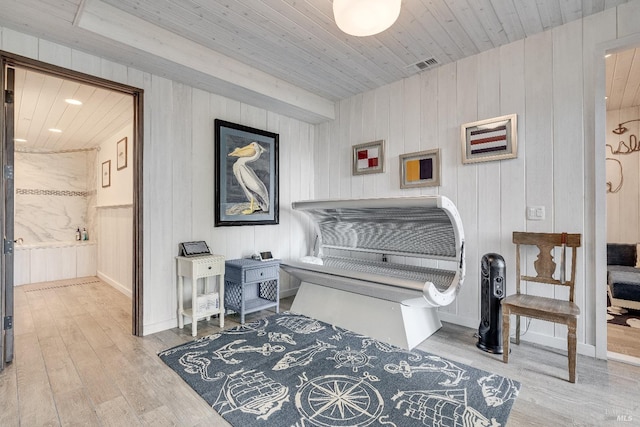 living area with wooden ceiling, baseboards, and wood finished floors