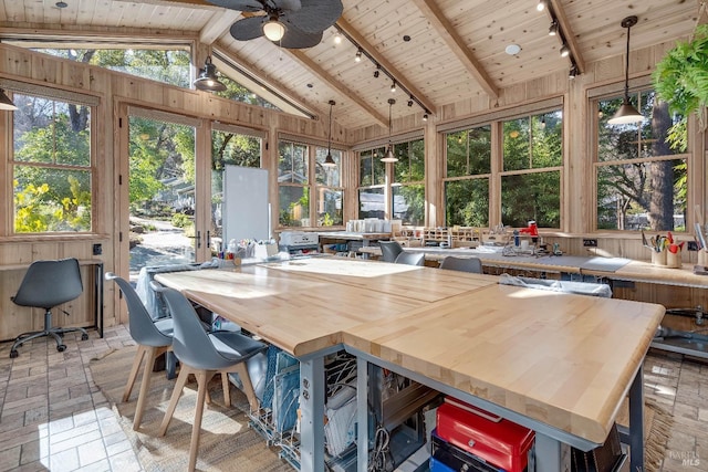 sunroom / solarium featuring vaulted ceiling with beams, ceiling fan, wooden ceiling, and rail lighting