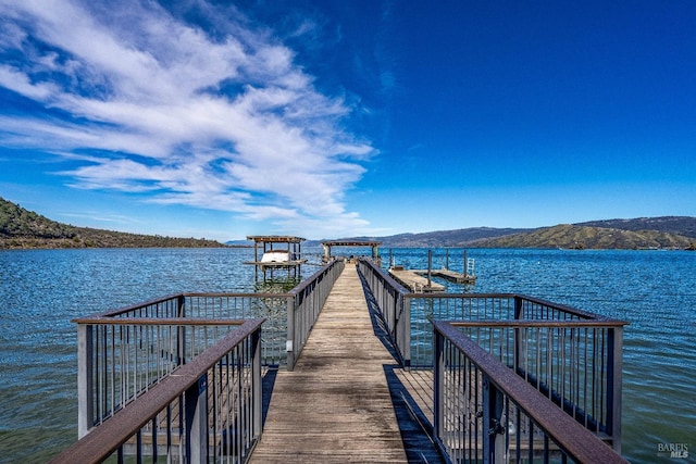 dock area featuring a water and mountain view