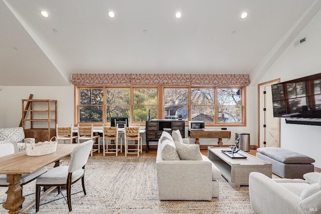 living room featuring lofted ceiling, visible vents, wood finished floors, and recessed lighting