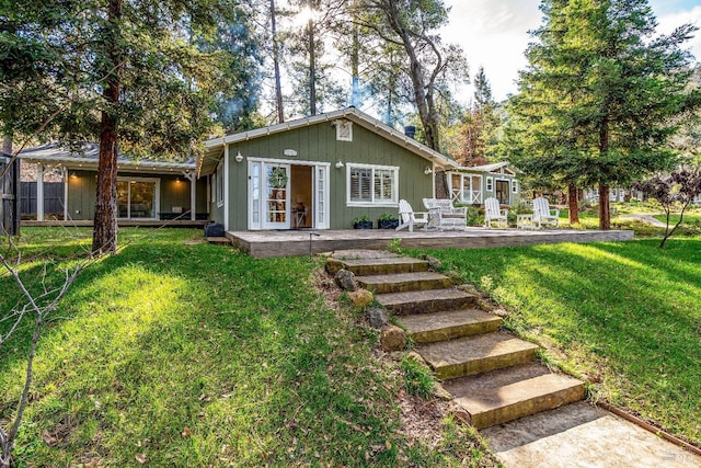 view of front facade with a front lawn and a patio