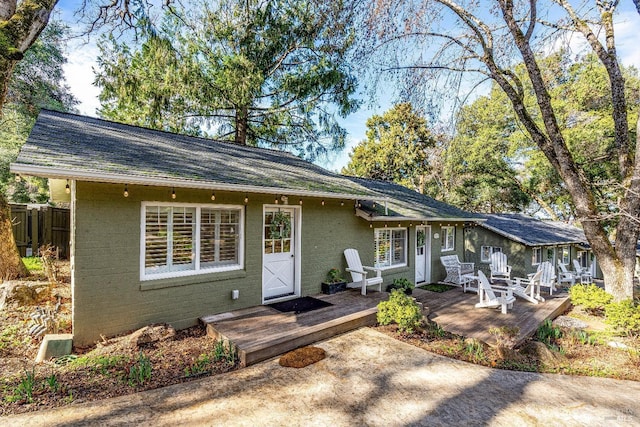 view of front of home with fence and a wooden deck