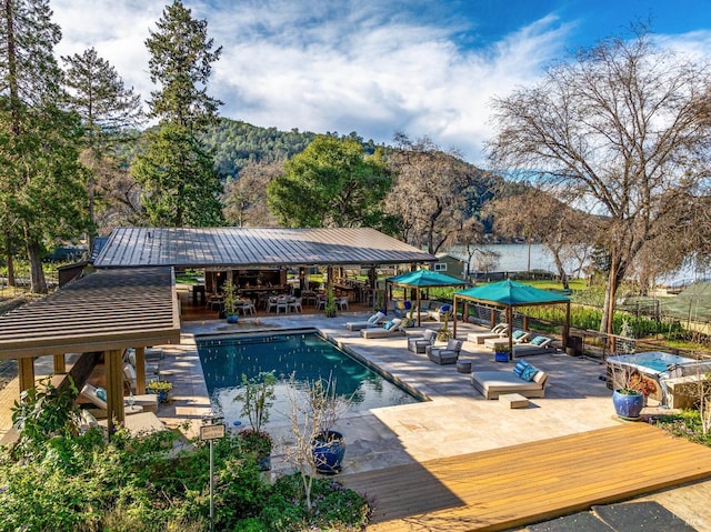 view of pool with a fenced in pool, a patio area, and a mountain view