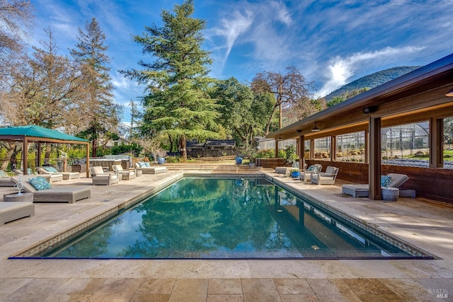 view of pool with a fenced in pool, a gazebo, a patio area, a fenced backyard, and an outdoor living space