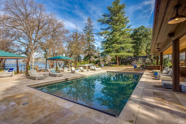 view of pool with a fenced in pool, a patio area, a fenced backyard, and a gazebo