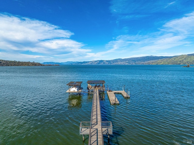 exterior space with a water and mountain view