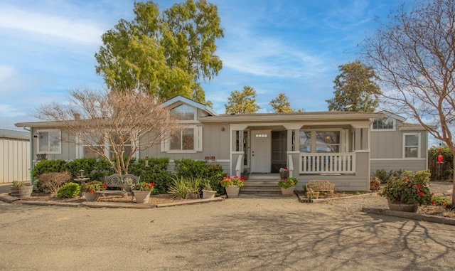 ranch-style house featuring a porch and board and batten siding