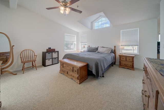 bedroom with lofted ceiling, light carpet, ceiling fan, and multiple windows