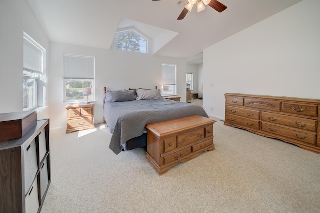 bedroom featuring light colored carpet, ceiling fan, vaulted ceiling, and baseboards