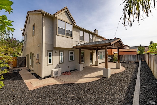 back of house featuring ac unit, a patio area, a fenced backyard, and stucco siding