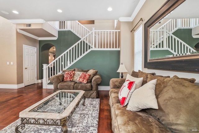living room with arched walkways, visible vents, stairway, ornamental molding, and wood finished floors