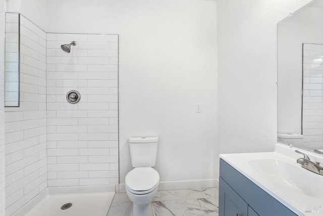 full bath featuring marble finish floor, tiled shower, toilet, and baseboards