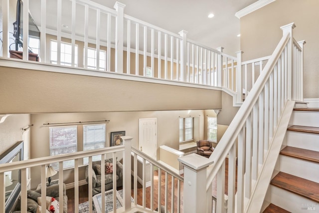 staircase with recessed lighting and a high ceiling