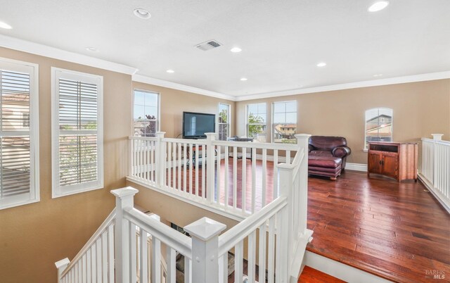 hallway with a healthy amount of sunlight, visible vents, and an upstairs landing