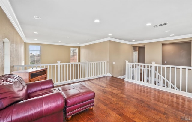 living area featuring recessed lighting, visible vents, wood finished floors, and an upstairs landing