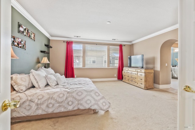 carpeted bedroom featuring ornamental molding, arched walkways, a textured ceiling, and baseboards