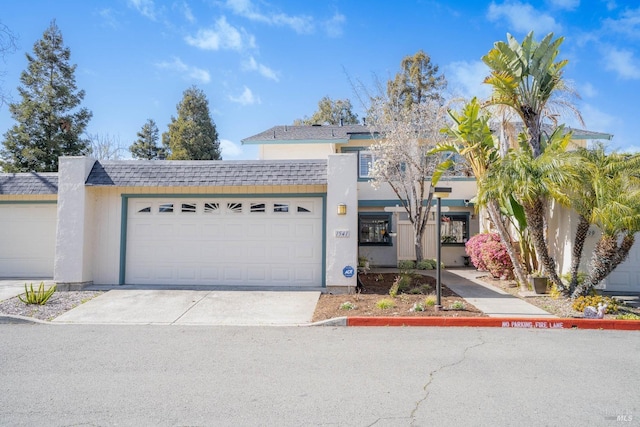 townhome / multi-family property with a garage, roof with shingles, and stucco siding