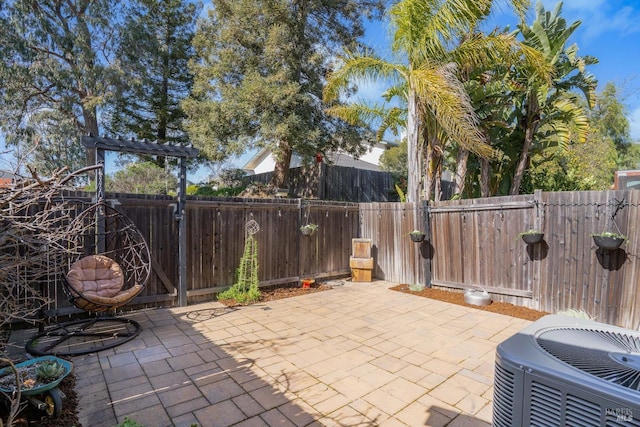 view of patio with a fenced backyard and central AC unit