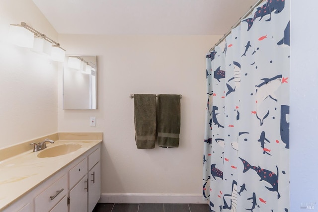 full bath featuring a shower with shower curtain, tile patterned flooring, vanity, and baseboards