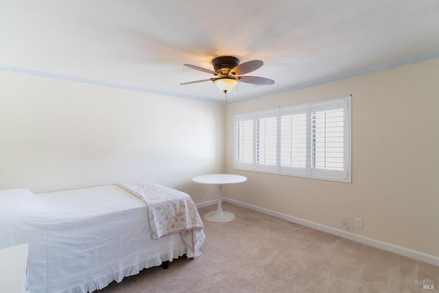 bedroom with ornamental molding, carpet flooring, ceiling fan, and baseboards