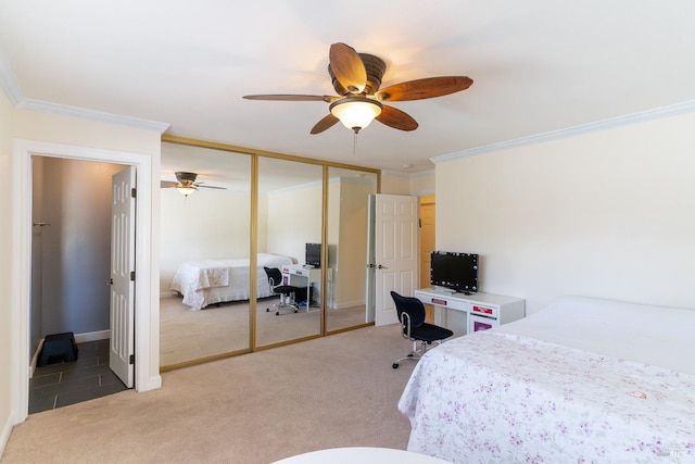 bedroom featuring a ceiling fan, crown molding, and light colored carpet