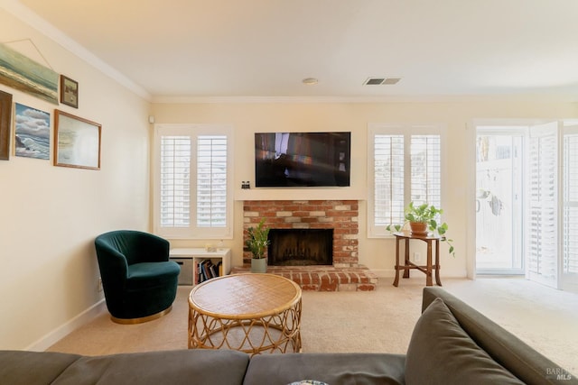 living area featuring visible vents, baseboards, crown molding, carpet floors, and a brick fireplace