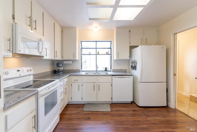 kitchen with white appliances, light countertops, a sink, and dark wood-style flooring