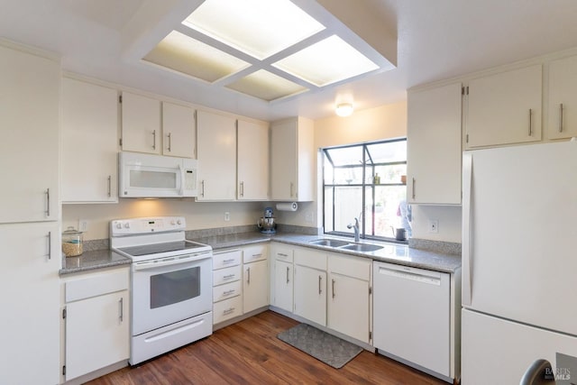 kitchen featuring white appliances, a sink, and dark wood-style flooring