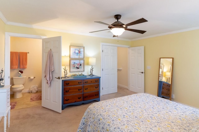 bedroom with ceiling fan, ensuite bathroom, light carpet, baseboards, and ornamental molding