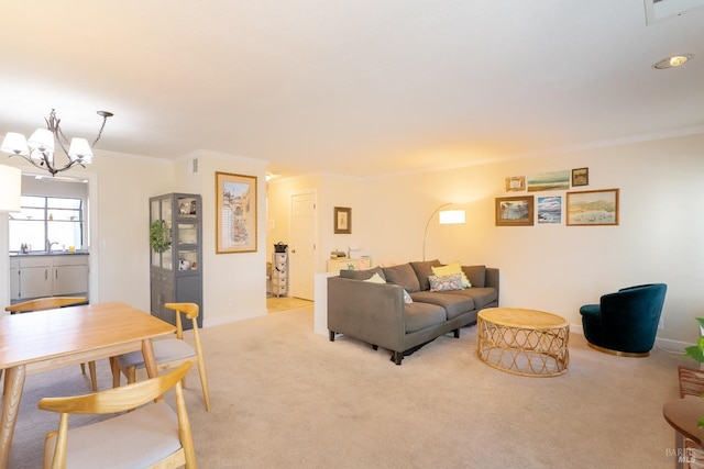 living area featuring crown molding, baseboards, a chandelier, and light colored carpet