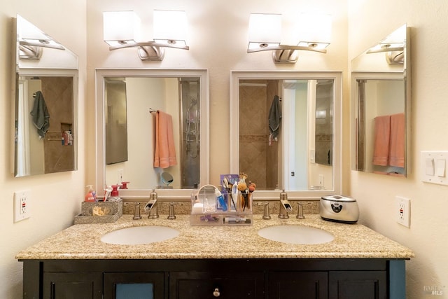 full bathroom with double vanity and a sink