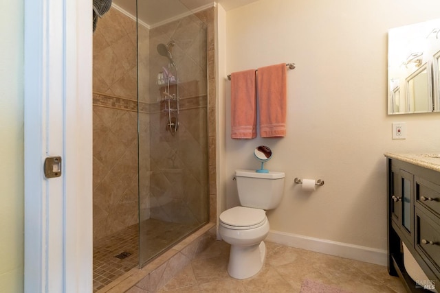 bathroom with toilet, a tile shower, vanity, baseboards, and tile patterned floors