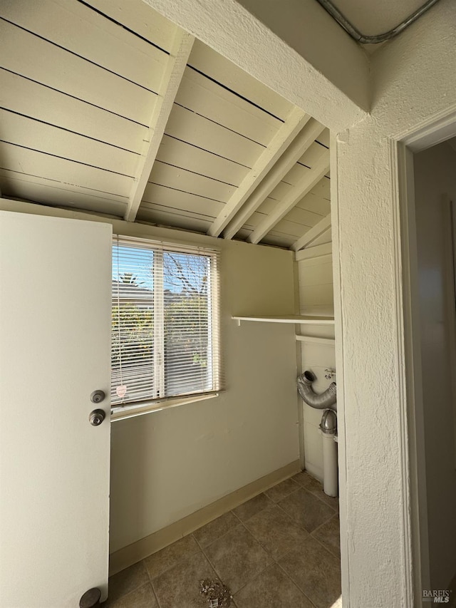 bathroom featuring lofted ceiling with beams, baseboards, wood ceiling, and tile patterned floors