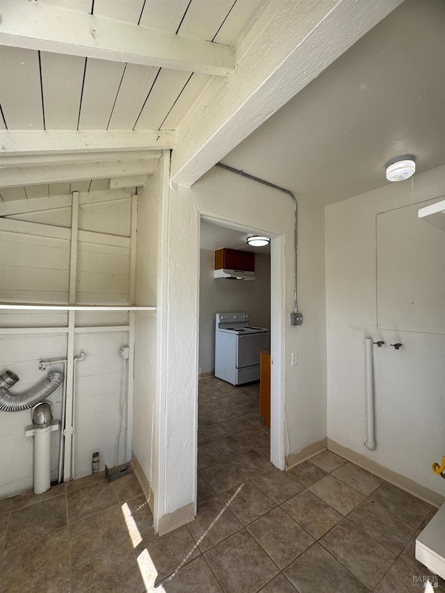 interior space featuring baseboards, washer / clothes dryer, beam ceiling, and tile patterned floors